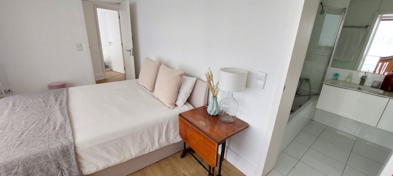 Room D with a double bed and the door open to its en-suite bathroom